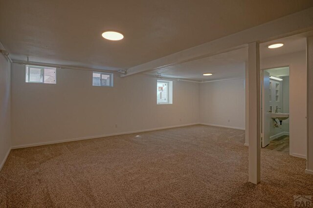 below grade area with carpet and baseboards