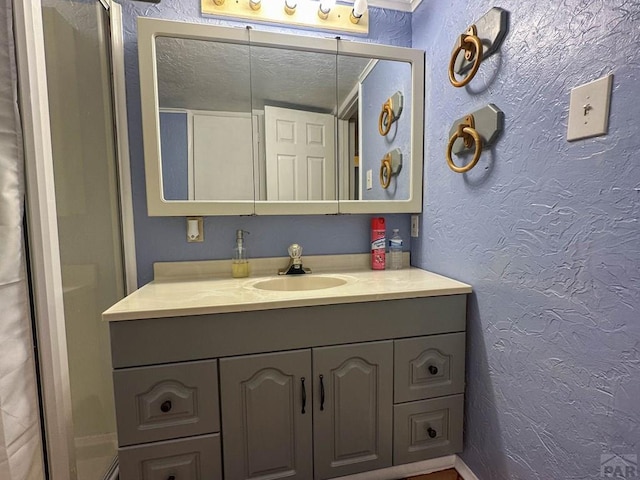 620 S 7th St, Springfield, CO 81073 - bathroom with a textured wall, vanity, and a textured ceiling