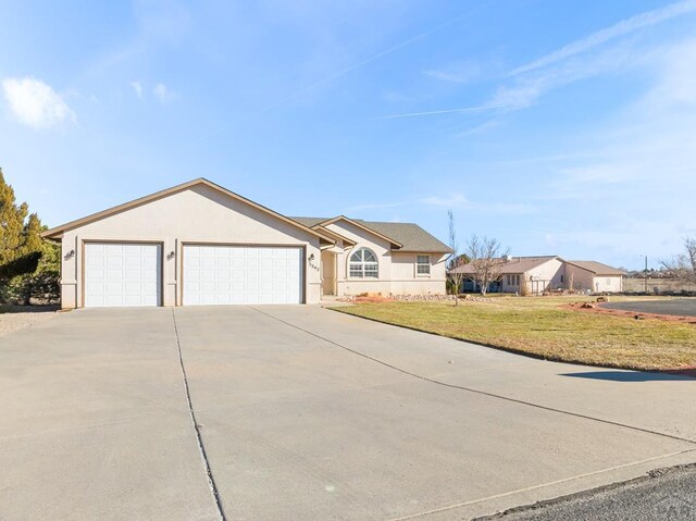 ranch-style house featuring concrete driveway, a front yard, an attached garage, and stucco siding