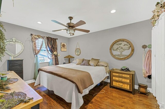 bedroom featuring a ceiling fan, recessed lighting, baseboards, and wood finished floors