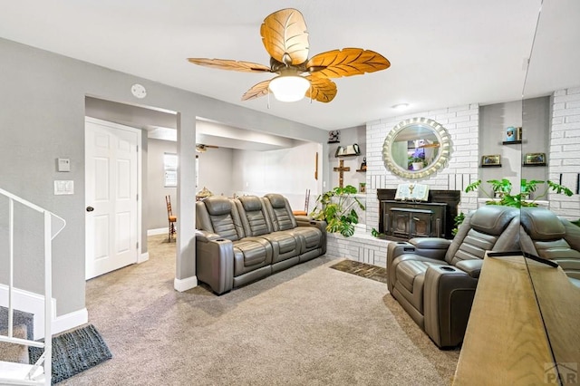 living room featuring carpet, a fireplace, ceiling fan, and baseboards