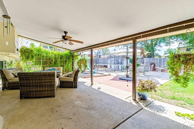 view of patio / terrace featuring a fenced backyard, a trampoline, ceiling fan, and an outdoor living space