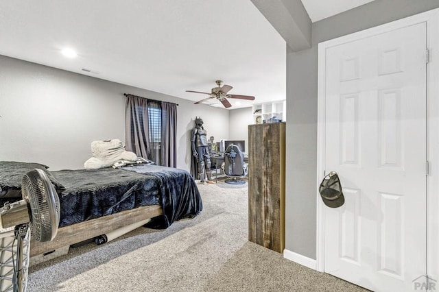 carpeted bedroom featuring ceiling fan and visible vents