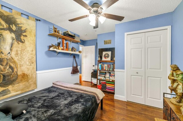 bedroom featuring a closet, ceiling fan, a textured ceiling, and wood finished floors