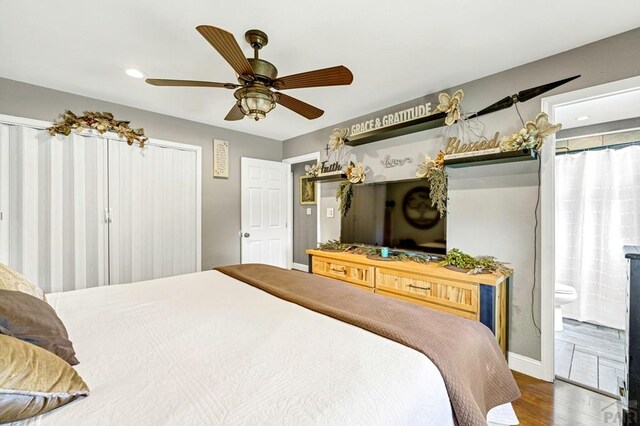 bedroom featuring recessed lighting, a ceiling fan, wood finished floors, and ensuite bathroom