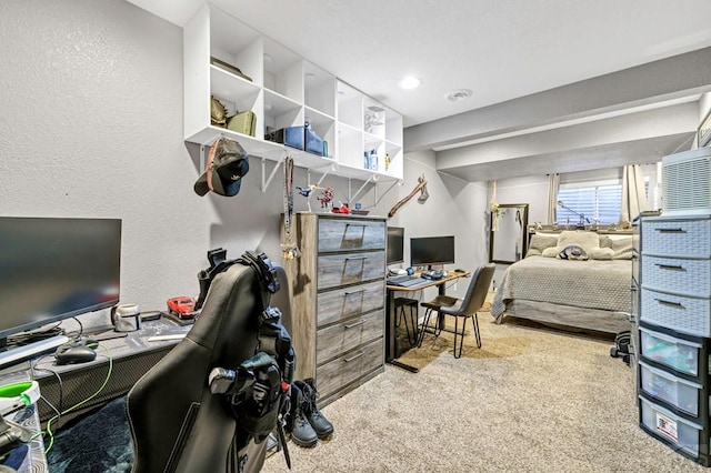 carpeted home office featuring a textured wall