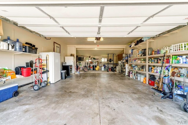 garage with freestanding refrigerator and a garage door opener