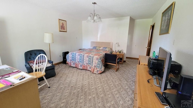 bedroom featuring a chandelier, a desk, baseboards, light colored carpet, and a textured ceiling