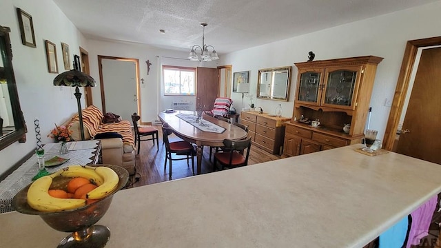 dining room featuring wood finished floors and a chandelier