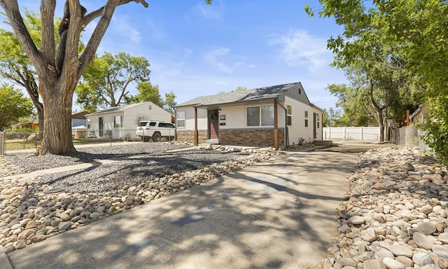3009 Baystate Ave, Pueblo, CO 81005 - view of front facade with concrete driveway, stone siding, and stucco siding