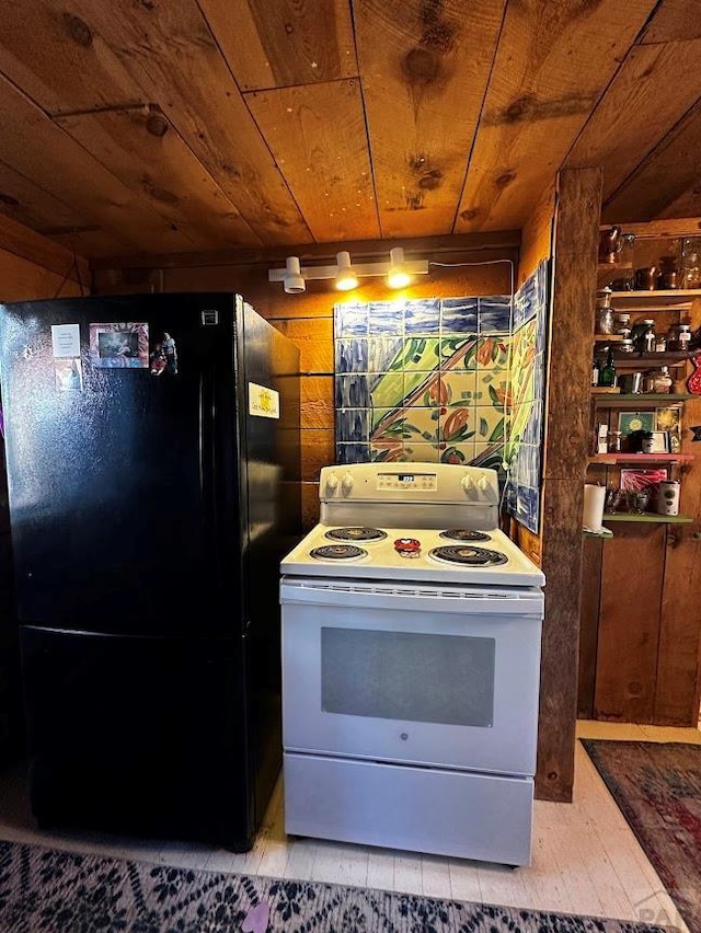 kitchen featuring wooden walls, wood ceiling, white electric stove, and freestanding refrigerator