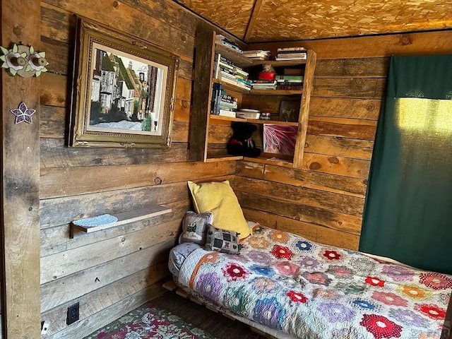 bedroom with wooden walls