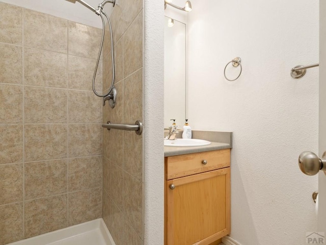 bathroom featuring a shower stall and vanity