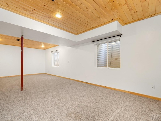 below grade area featuring carpet flooring, baseboards, wooden ceiling, and recessed lighting