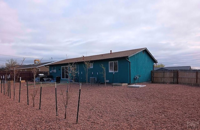 back of house with fence