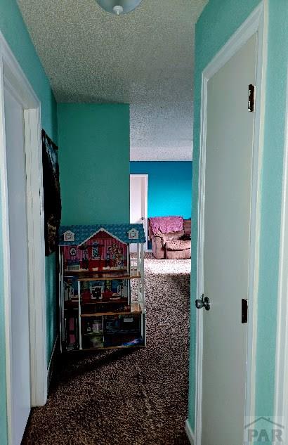 corridor with a textured ceiling