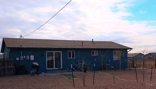 back of property featuring fence, cooling unit, and a patio