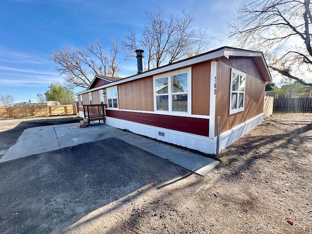 view of side of property with a patio area and fence