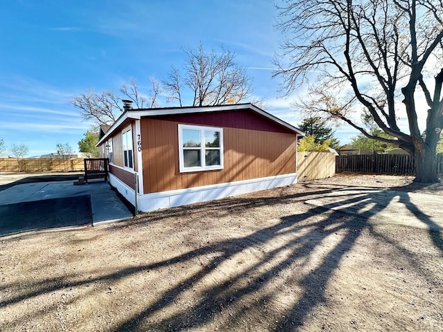 view of home's exterior featuring a patio area and fence