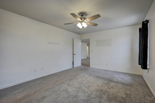 empty room featuring carpet, baseboards, and a ceiling fan