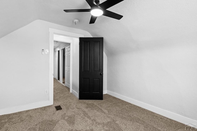 bonus room with ceiling fan, visible vents, carpet floors, lofted ceiling, and baseboards