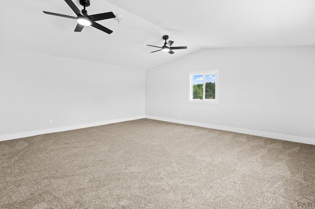 carpeted empty room featuring baseboards, a ceiling fan, and lofted ceiling
