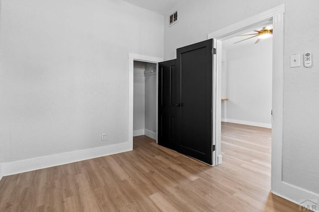 unfurnished bedroom with visible vents, baseboards, and light wood-type flooring