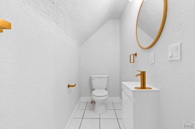 half bathroom featuring baseboards, tile patterned floors, a textured ceiling, toilet, and lofted ceiling