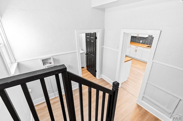 stairs featuring wood finished floors
