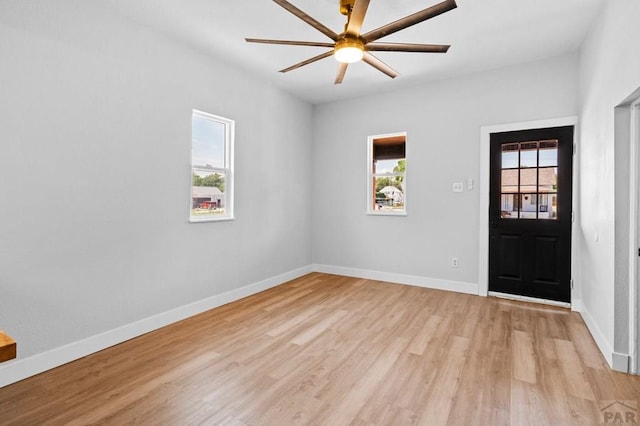 unfurnished room with light wood finished floors, baseboards, and ceiling fan