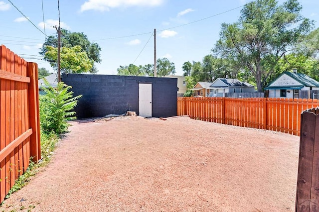 view of yard with a fenced backyard and an outdoor structure