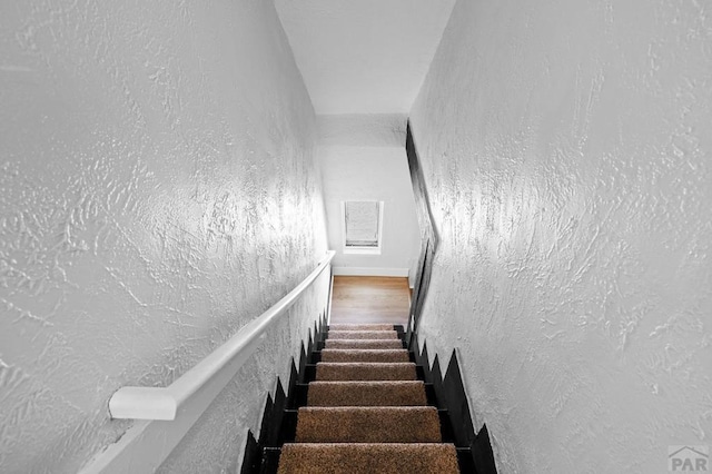 stairs with a textured wall and visible vents
