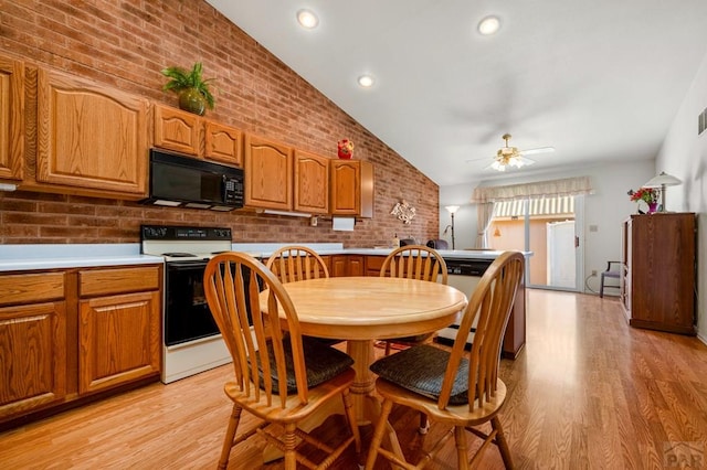 2106 Chatalet Ln Unit I, Pueblo, CO 81005 - dining room featuring lofted ceiling, brick wall, light wood finished floors, and ceiling fan