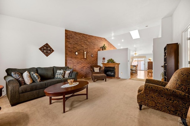 2106 Chatalet Ln Unit I, Pueblo, CO 81005 - living area with lofted ceiling, light colored carpet, a skylight, brick wall, and a fireplace