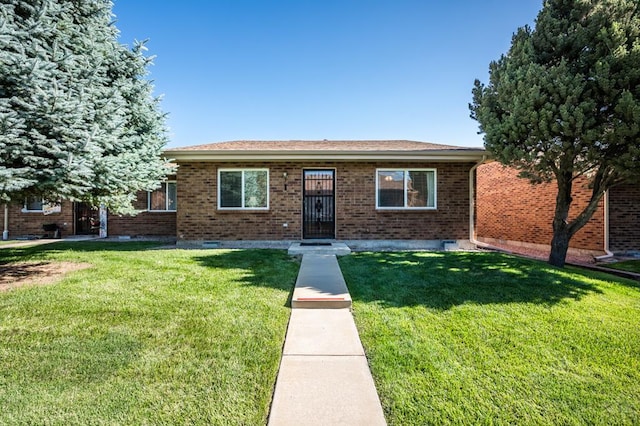 2106 Chatalet Ln Unit I, Pueblo, CO 81005 - view of front of house with a front lawn, brick siding, and crawl space