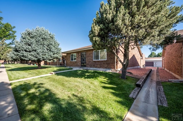2106 Chatalet Ln Unit I, Pueblo, CO 81005 - view of front of home featuring a front yard and brick siding