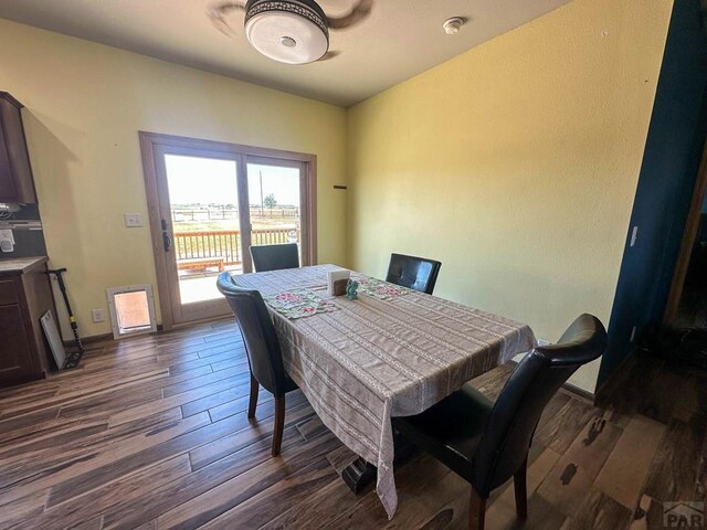 dining space with dark wood-type flooring