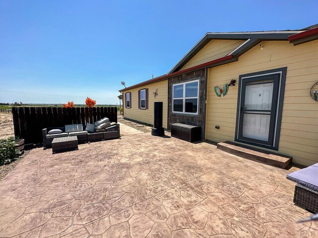 exterior space featuring fence and an outdoor hangout area