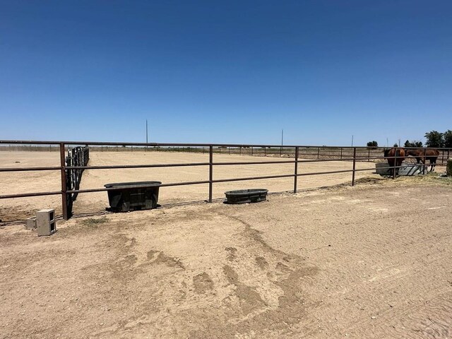 view of yard featuring an enclosed area and a rural view