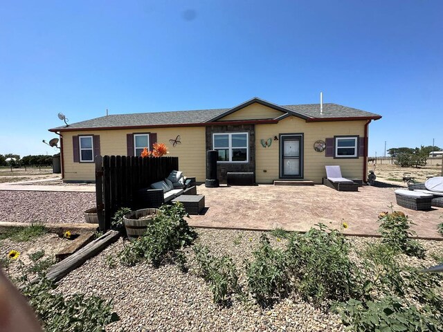 ranch-style home with a patio area, fence, and an outdoor hangout area