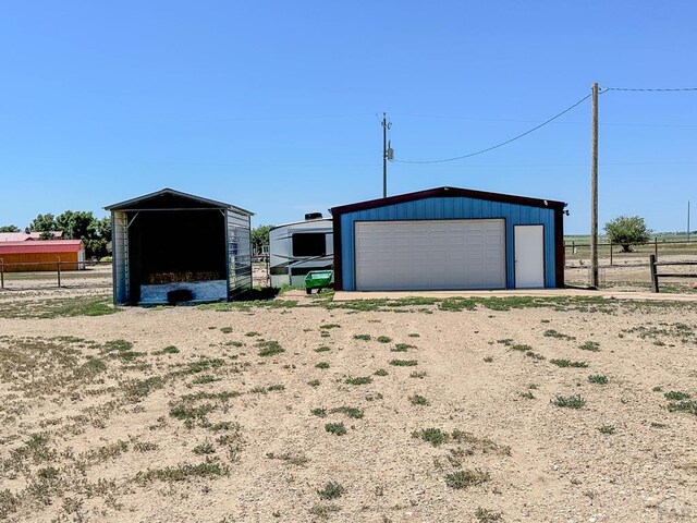 detached garage featuring fence