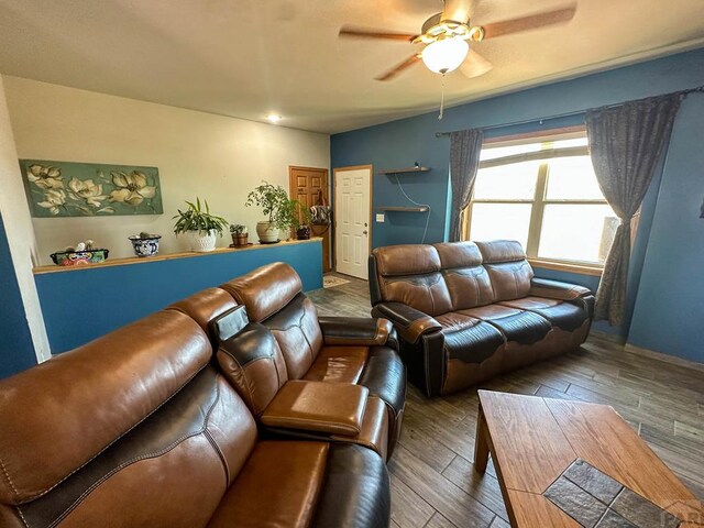 living room with a ceiling fan and wood finished floors