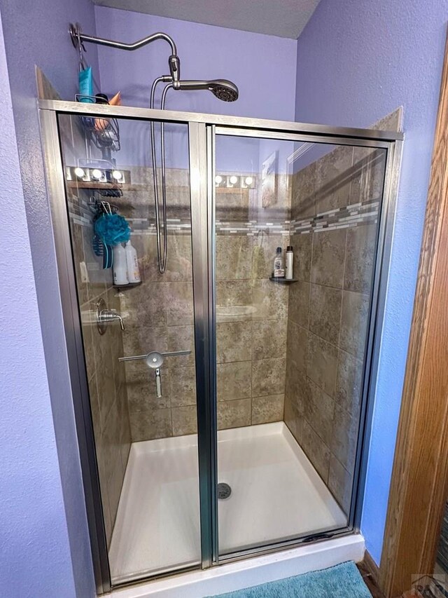 bathroom with a shower stall