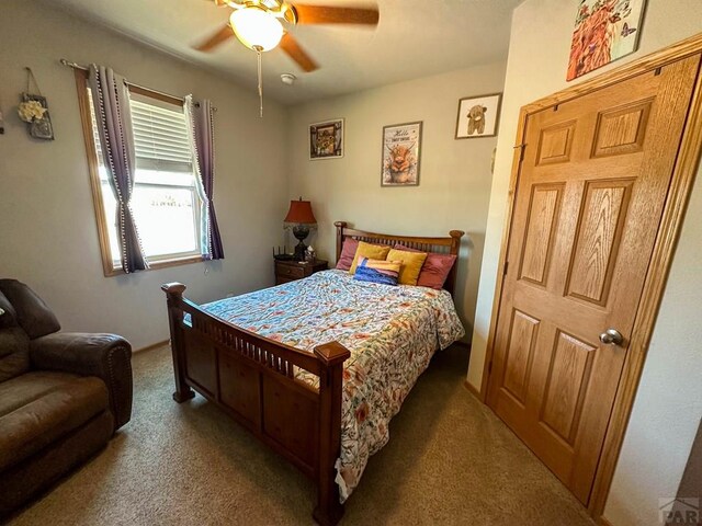 bedroom featuring light carpet and ceiling fan