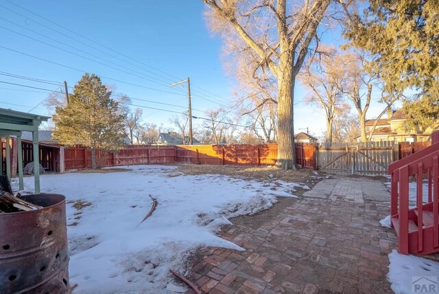 yard covered in snow featuring a fenced backyard