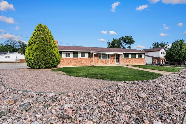 3216 Baltimore Ave, Pueblo, CO 81008 - ranch-style house featuring brick siding and a front yard