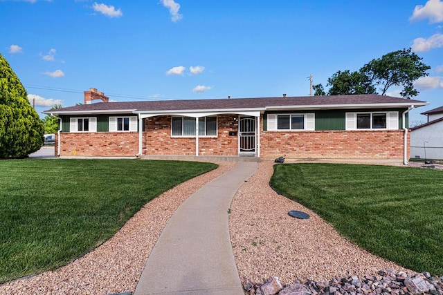 3216 Baltimore Ave, Pueblo, CO 81008 - ranch-style house featuring brick siding, a front yard, and a chimney