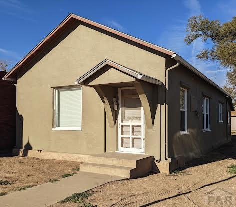 back of property featuring stucco siding