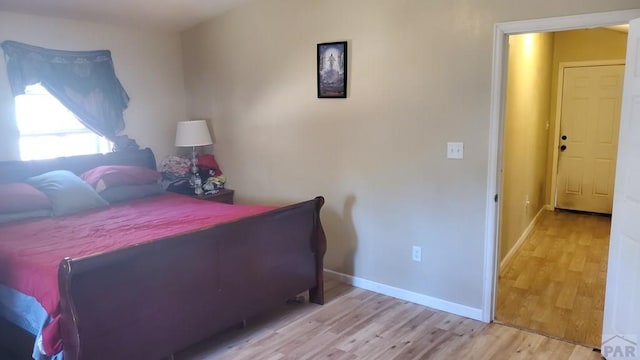 bedroom with wood finished floors and baseboards