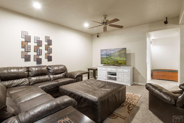 living room featuring light carpet, ceiling fan, baseboards, and recessed lighting